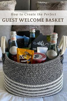 a basket filled with drinks and snacks on top of a bed