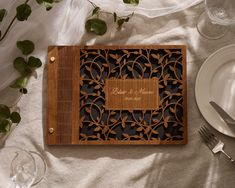 a personalized cutting board on top of a table with silverware and napkins