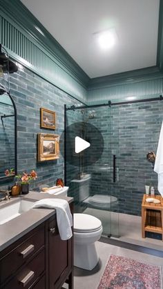 a bathroom with a toilet, sink and shower stall in the middle of the room