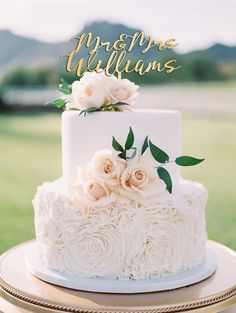 a white wedding cake with flowers on top