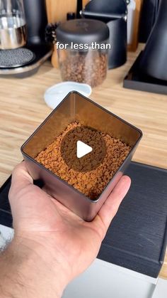 a person holding a metal bowl with food in it on top of a stovetop