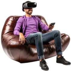 a man sitting on a bean bag chair wearing a virtual reality headset