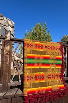 a blanket is hanging on a wooden fence