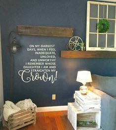 a living room with a blue wall and wooden crates in front of the couches