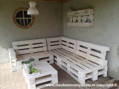 an outdoor seating area made out of wooden pallets