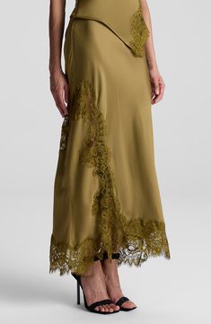 Tonal lace trim highlights the asymmetric silhouette of this smooth satin skirt. 35" length 100% viscose with 100% nylon contrast Dry clean Imported Satin Lace Skirt, Skirts Trend 2024, Tailor Clothes, Satin Maxi Skirt, Tailored Clothes, Lace Midi Skirt, Skirt Trends, Lace Outfit, Satin Midi Skirt