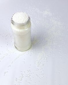 a jar filled with white powder sitting on top of a table