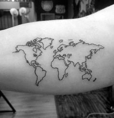 a black and white world map tattoo on the arm