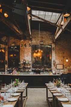 an empty restaurant with long tables and chairs set up for formal dinner or party guests