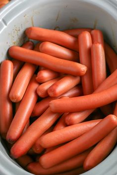 there are many small hot dogs in the bowl together, and they look like carrots