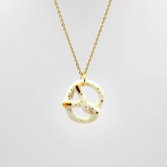 This small porcelain pretzel pendant is a perfect gift for a foodie or even a great party favor! It was made by hand from porcelain and decorated with gold. It is small, about 2.2 x 2.7 cm and every pretzel is a little bit different. It comes on a 60 cm gold-plated stainless steel chain or on a 40 cm gold-plated silver chain.  Comes in a nice-looking box, ready to be gifted. Product colors may vary slightly from the photo. The dimensions, weight, and modeling may vary slightly as a handcrafted i White Pretzels, Pretzel Necklace, Steel Accessories, Stainless Steel Accessories, Ceramic Earring, Gold Necklaces, Necklace Handmade, Gold Plated Silver, Stainless Steel Chain