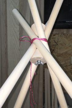 several white sticks tied together with pink string