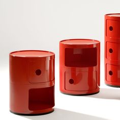 three red round tables with holes in the top and bottom, one on each side