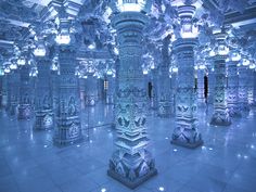 an elaborately decorated room with columns and chandeliers in blue hued lighting