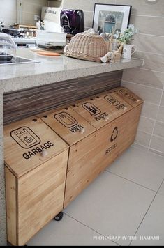 a kitchen counter top with wooden drawers underneath it