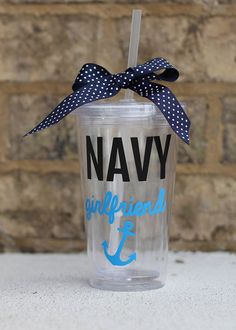 a clear cup with a blue and white polka dot bow on the side that says navy girlfriend