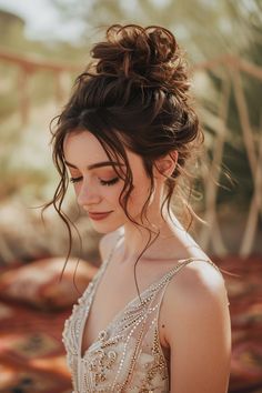 a woman in a wedding dress looking down at her phone