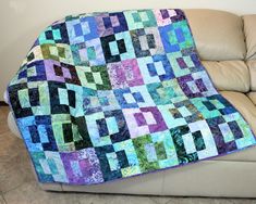 a couch with a quilt on top of it