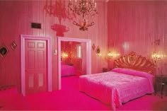 a bedroom with pink carpet, chandelier and bed