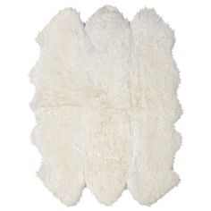 a white sheepskin rug on a white background