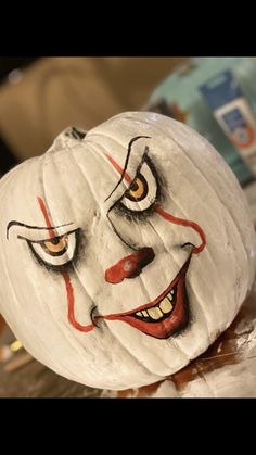 a white pumpkin with a painted face on it