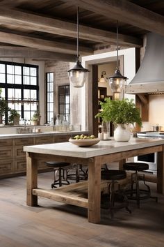 a large kitchen with an island table surrounded by stools and lights hanging from the ceiling