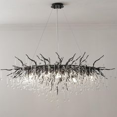 a chandelier made out of branches and glass beads