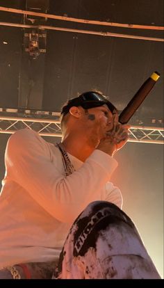 a man holding a baseball bat on top of a stage