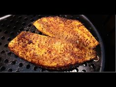 two pieces of fried fish in a frying pan