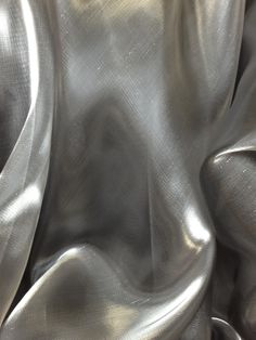 a metallic cloth is shown in close up with the fabric pulled back to show it's folds