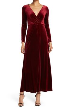 The Rosalie is a glamorous velvet maxi dress that's sure to turn covetous heads wherever you go. 57" length (size S) Surplice neck Long sleeves Back zip closure Lined Shell is 90% polyester, 10% spandex; lining is 100% polyester Machine wash, line dry Imported Model Stats: 5'10" height; 34" bust; 27" waist; 35" hips. Model is wearing size S. Elegant Velvet V-neck Maxi Dress, Glamorous Velvet Maxi Dress, Velvet Maxi Dress For Night Out, Fitted Velvet V-neck Maxi Dress, Glamorous Velvet Evening Maxi Dress, Glamorous Velvet Maxi Dress For Evening, Holiday Evening Velvet V-neck Dress, Holiday Velvet V-neck Evening Dress, Winter Maxi Dress For Evening