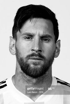 a black and white photo of a man with a beard wearing a soccer jersey, looking at the camera