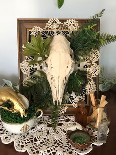 a table topped with plates and bowls filled with plants on top of a doily