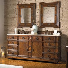 a bathroom vanity with two mirrors above it