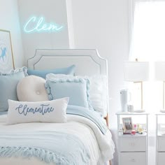 a bedroom with white walls and blue bedding