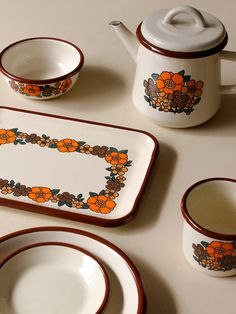 a table topped with plates and cups filled with food next to a teapot, cup and saucer