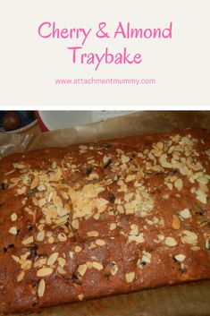 a loaf of cherry and almond tray bake on a baking sheet with text overlay