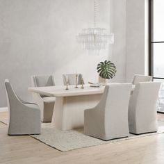 a dining room table with four chairs around it