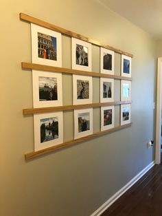 a wall with several pictures hanging on it