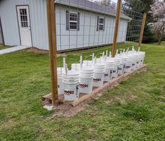 several buckets are lined up in front of a building