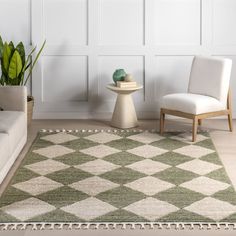 a green and white rug sitting on top of a wooden floor next to a chair