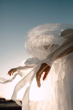 a woman wearing a white dress with sheer fabric