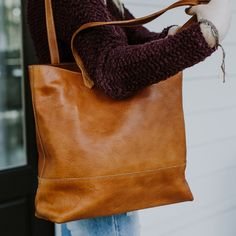 At first glance, you’ll notice the Madison Totes are a work of art. Now whether you choose full leather or waxed canvas is up to you, but as we like to say: “Either choice is the right choice.” But upon closer inspection you’ll realize the true genius to these totes – they are organizational wonders. The Madison Totes are designed with interior pockets to keep your important items separate and safe. There’s an open pocket for your cell phone, two pen slots, and two additional larger pockets for Cognac Saddle Shoulder Bag For Daily Use, Everyday Saddle Shoulder Bag With Leather Backing, Everyday Cognac Satchel Saddle Bag, Everyday Cognac Satchel Bucket Bag, Everyday Saddle Satchel With Leather Handles, Everyday Saddle Satchel With Removable Pouch, Brown Saddle Bag For Daily Use In Fall, Soft Leather Saddle Bag For Everyday Use, Everyday Soft Leather Saddle Bag