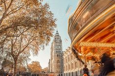 people riding on a merry go round in the city