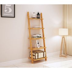 a tall wooden shelf sitting next to a lamp on top of a white tiled floor