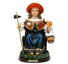 a figurine of a woman holding a broom and pot with an orange hat on her head