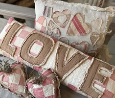 two decorative pillows with the word love on them