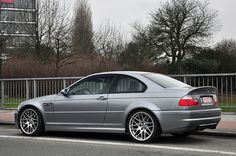 a silver car is parked on the side of the road