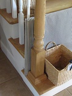 a basket is sitting on the stairs next to some towels and other items in a basket