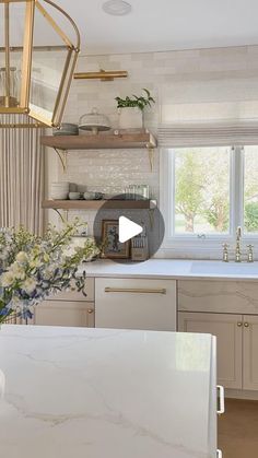 a kitchen with marble counter tops and white cabinets